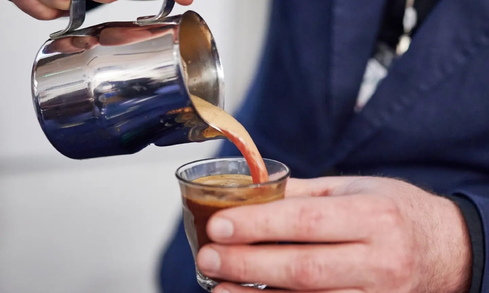 Barista pouring latte art at the London Coffee Festival